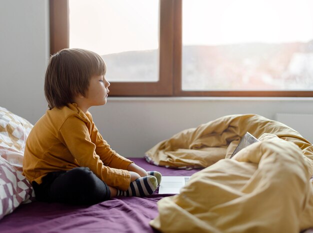 Boy sitting in bed and learning