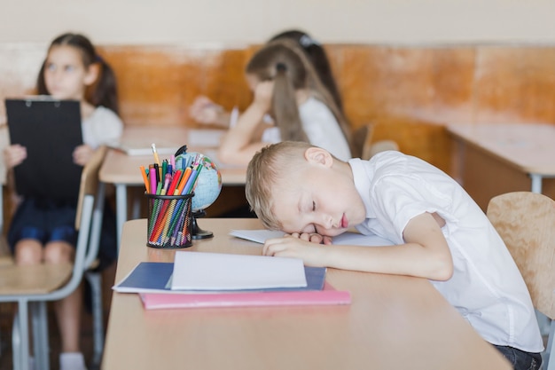 Boy sleeping during lesson in school