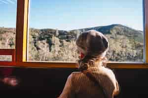 Free photo boy standing at window in train