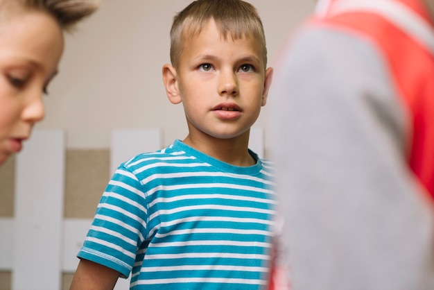 Boy standing with classmates