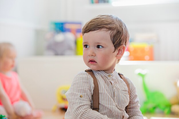 Boy in striped shirt looking away