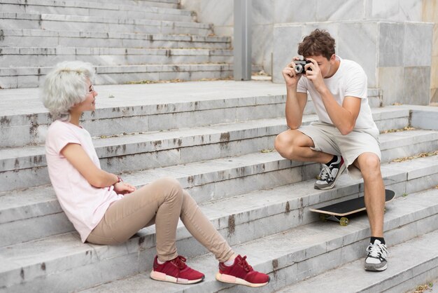 Boy taking a photo of his girlfriend