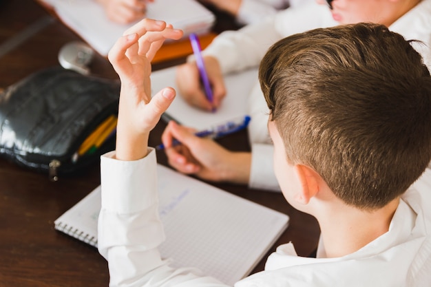 Free Photo boy thinking doing homework at desk 