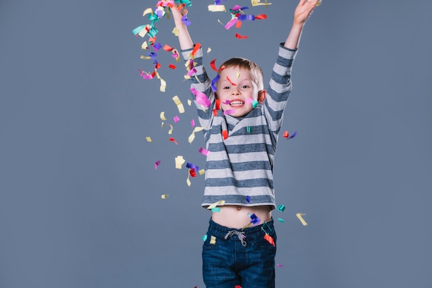 Free photo boy throwing confetti