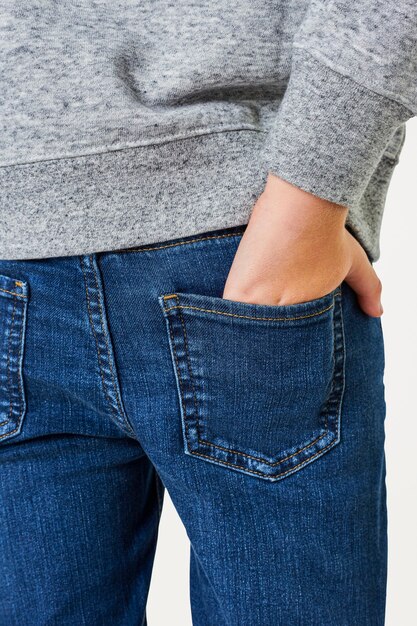 Boy wearing gray sweater with jeans 