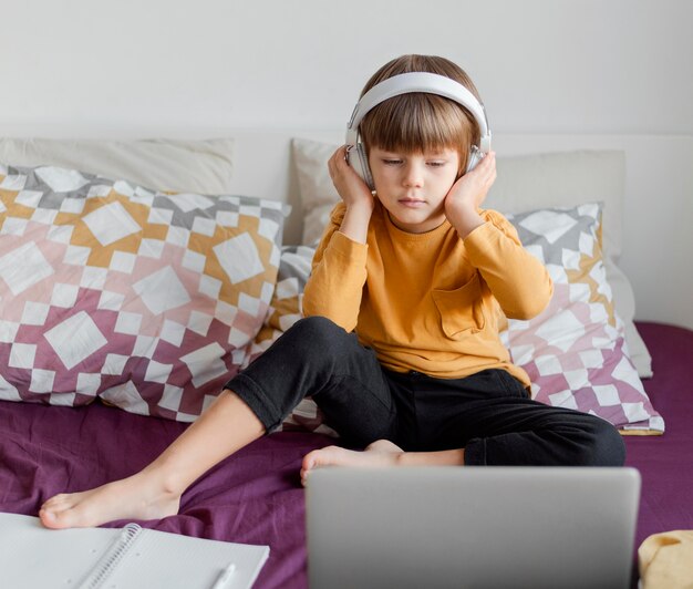 Boy wearing headphones and learning