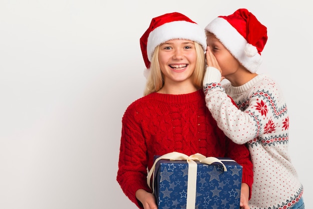 Boy whispering in girl's ear