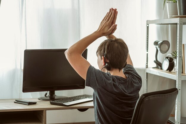 Boy winning an online game with his friends