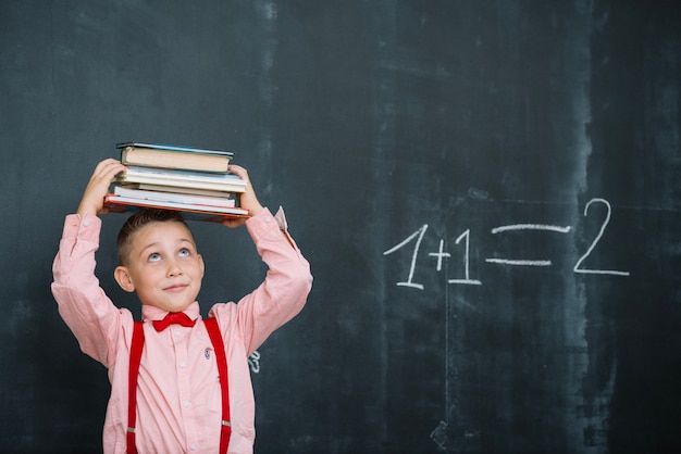 Free photo boy with books in math class