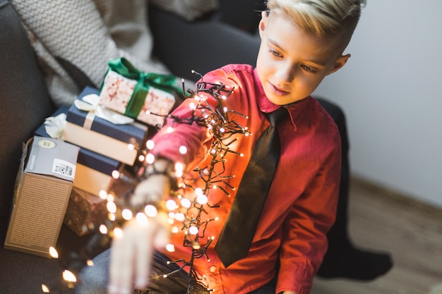 Free photo boy with christmas lights