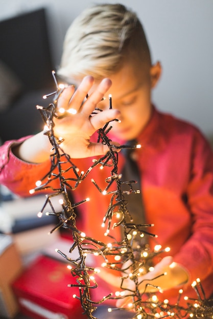 Free photo boy with christmas lights