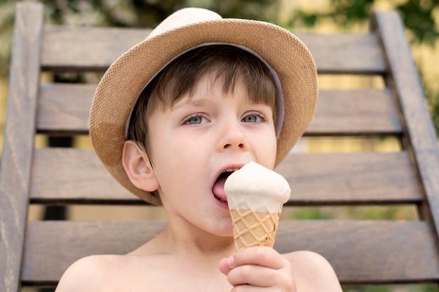 Boy with hat eating ice cream