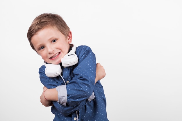 Boy with headphone embracing himself