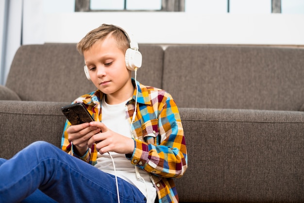 Free Photo boy with headphones using smartphone