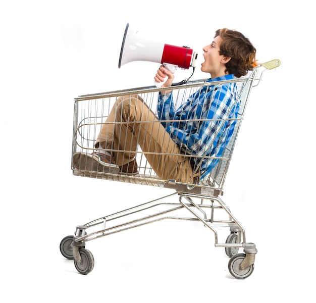 Boy with a megaphone in a shopping cart