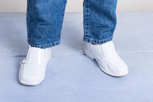 Boy with white shoes stepping on the floor