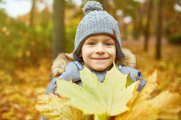 Boy with yellow leaves