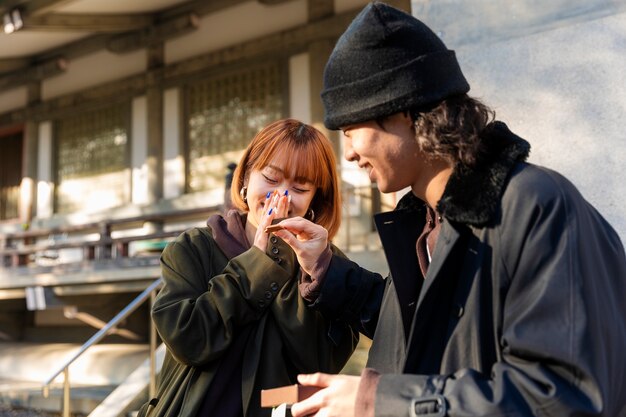 Boyfriend feeding chocolate sweets to his girlfriend while on a date