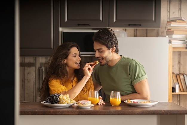 Boyfriend and girlfriend eating waffles together at home