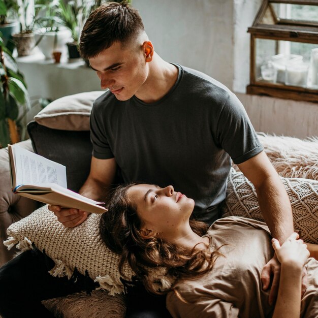 Boyfriend reading a love story for his girlfriend