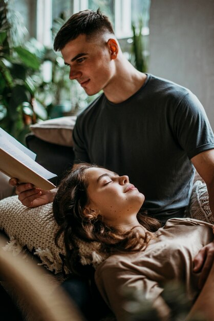 Boyfriend reading a love story for his girlfriend