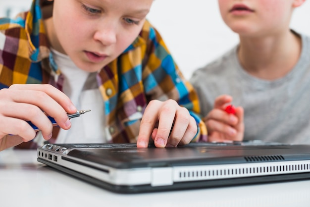 Boys fixing laptop