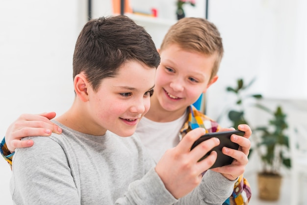 Boys playing with smartphone