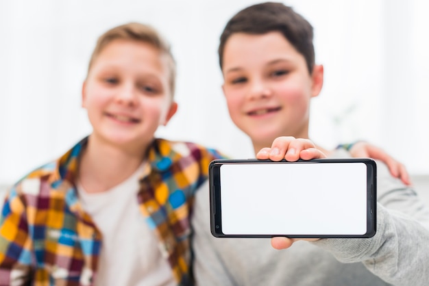 Free photo boys presenting smartphone template