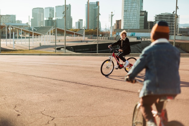 Free photo boys riding their bikes outdoors in the city