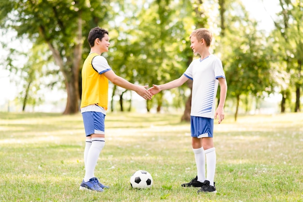 Boys shaking hands before a football match