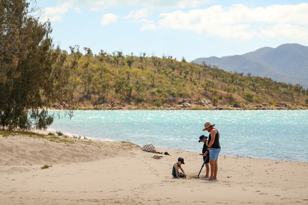 Boys using a metal detector searching for treasure