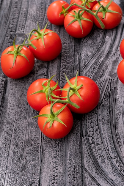 branch of cherry tomato on wooden texture top view