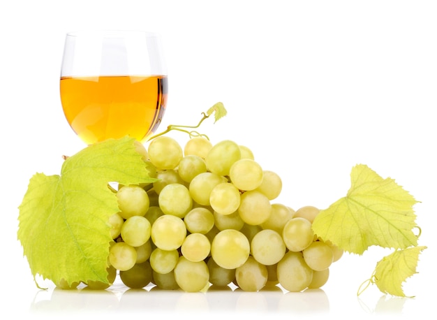 Branch of grapes and glass of wine isolated on white