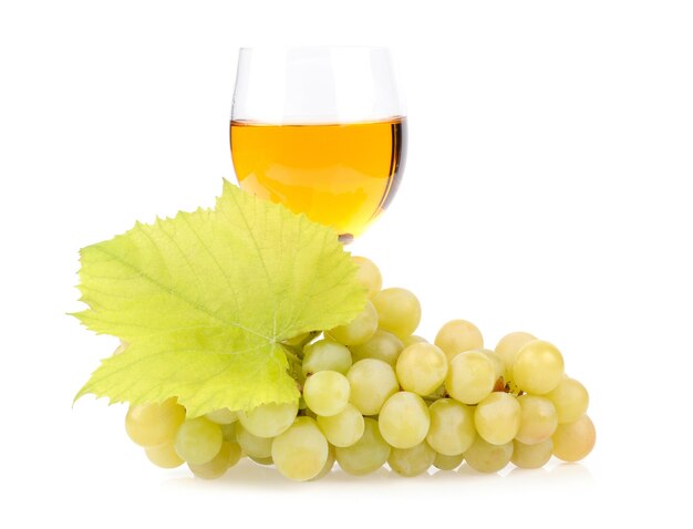 Branch of grapes and glass of wine isolated on white