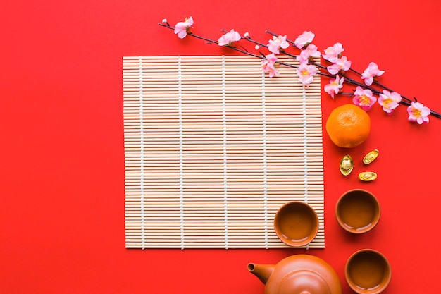 Branch and tea ceremony supplies near napkin