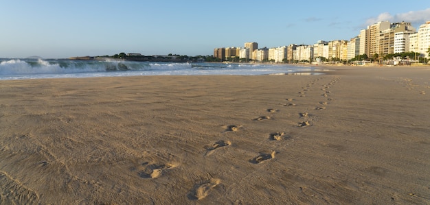 Free Photo brazilian beach with footprints in the sand and wild waves of the ocean on a sunny summer day