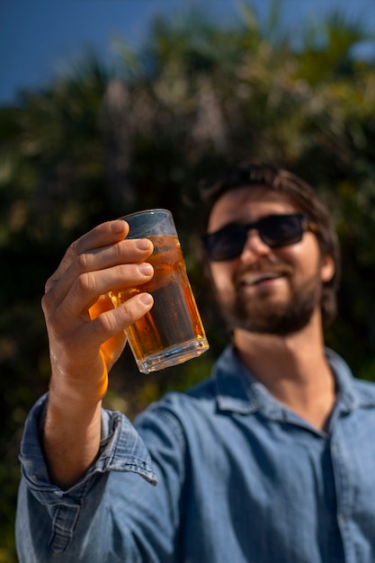 Brazilian man having guarana drink outdoors