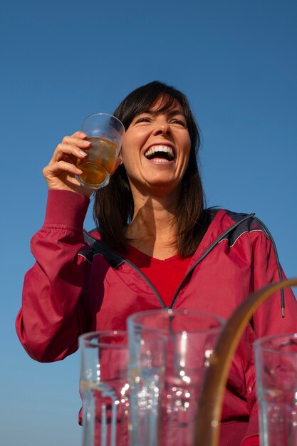 Brazilian woman having guarana drink outdoors