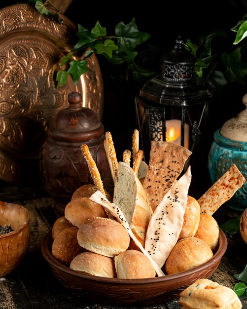 bread baguette breadsticks and buns with sesame in bowl