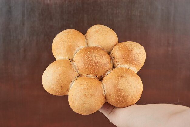 Bread bun in the hand of the baker.