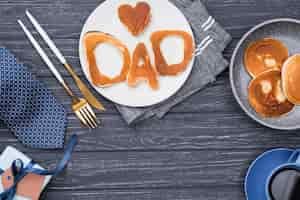 Free photo bread letters for father's day on wooden background