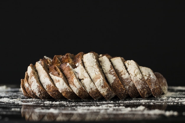 Free photo bread slices against black background