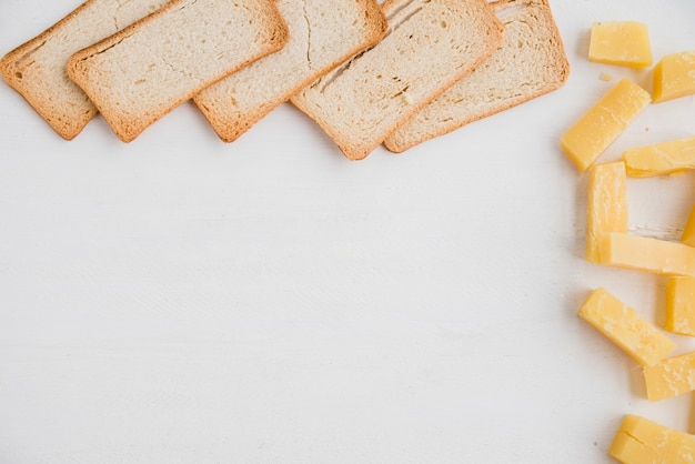 Free Photo bread slices with cheddar cheese slice on white background