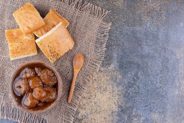 Bread slices with a cup of fig confiture