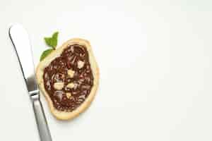 Free photo bread with chocolate paste on a light background