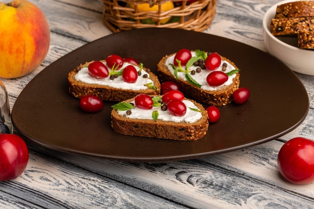 bread with cream bread loafs inside brown plate on grey