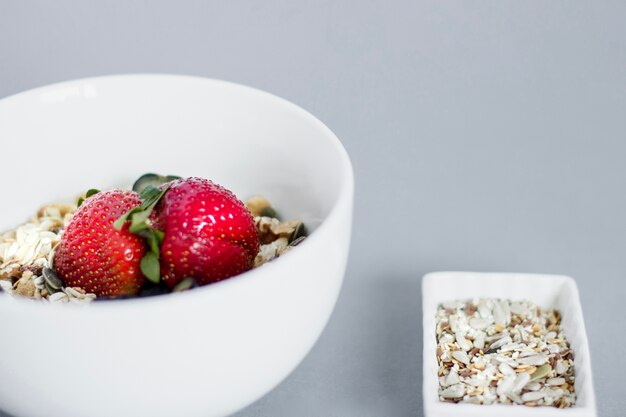 Breakfast bowl with oat flakes and strawberries