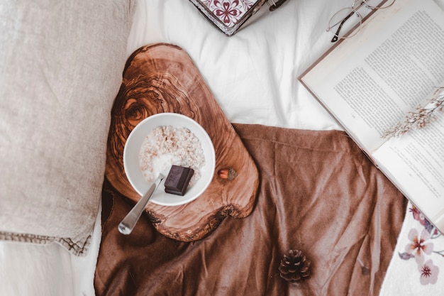 Breakfast food near book on bed