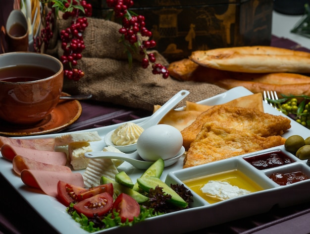 Breakfast plate with mixed ingredients and tea