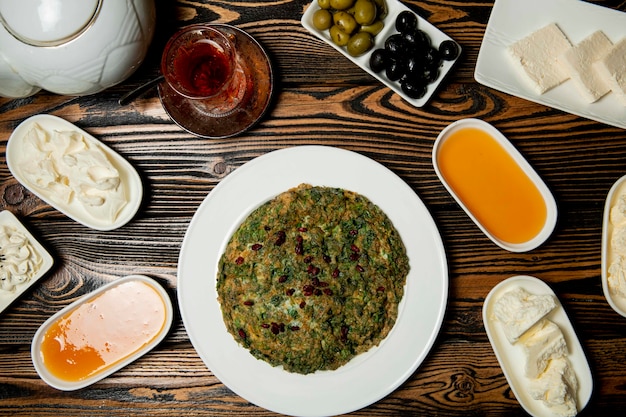 Breakfast set of cheeses, honey, tea and a azeri traditional kyukyu